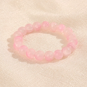 Bracelet de perles rondes roses translucides 10mm sur fond de tissu texturé pour femme