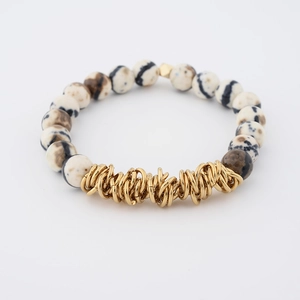 Detail of 8mm white natural stone beads with golden metal wrap and hexagonal spacer