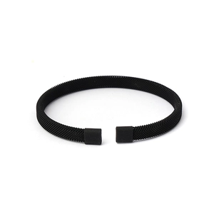 Detail of black stainless steel woven mesh bracelet with matte finish square end caps
