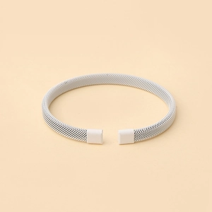 Detailed view of silver mesh woven steel wire bracelet with square decorative ends