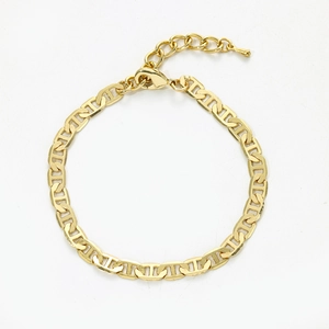 Close-up of golden flat mariner chain anklet featuring lobster clasp and extension link