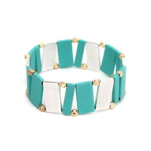 Detailed view of handmade geometric bracelet with turquoise tiles and golden beads
