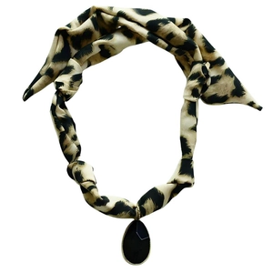 Detail of leopard print silk scarf necklace with a black water drop pendant