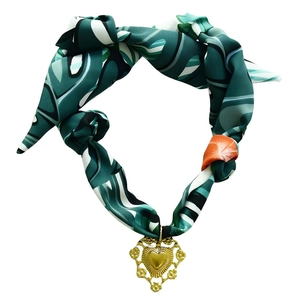 Deep green patterned silk scarf necklace featuring a vintage gold heart pendant with floral motifs