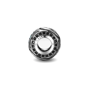Detailed macro of S925 sterling silver bead charm with blue stones and hollow patterns