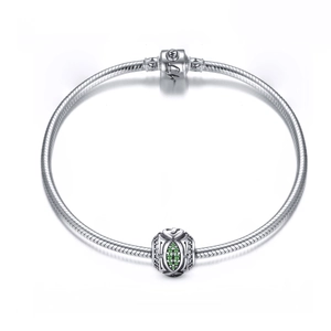 Close-up of S925 silver snake chain bracelet featuring a green gemstone charm detail