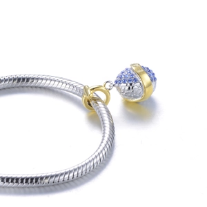 Detailed close-up of S925 silver globe charm with blue zircons and golden GIA engraving