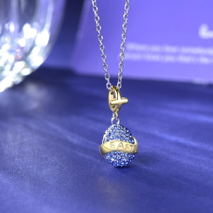 S925 sterling silver Easter egg pendant with blue stones and golden Easter ribbon engraving