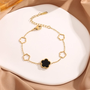 Golden stainless steel bracelet with cutout and solid black five-leaf clover charms
