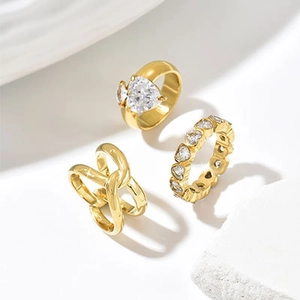 Detailed view of a 14k gold plated three-piece ring set with heart-shaped diamonds