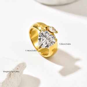 Detail view of gold stainless steel ring with two heart-shaped cubic zirconia stones