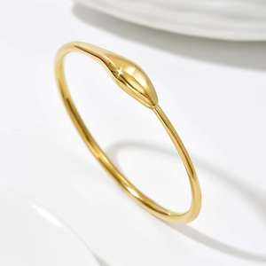 Minimalist 14k gold-plated stainless steel bangle with sleek teardrop accent detail