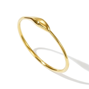 Macro view of minimalist 14k gold-plated stainless steel thin bangle with drop detail