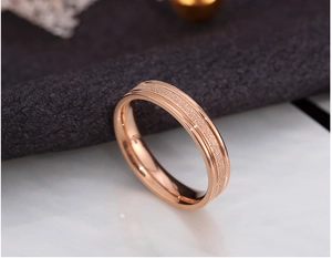 Macro detail of rose gold titanium steel ring with sandblasted texture and polished edges