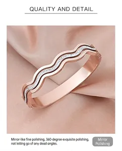 Close-up of rose gold wave bangle with inlaid rhinestones on pink silk background
