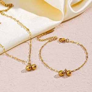 Detail view of 14K gold plated anklet set with smooth metal beads on minimalist chain