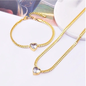 Elegant gold heart pendant necklace and bracelet set with cubic zirconia stones