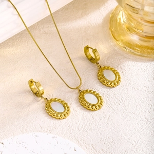 Gold plated stainless steel jewelry set with oval shell pendant and matching earrings