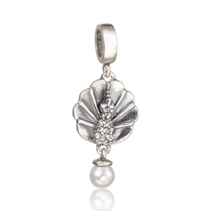 Detailed macro view of retro silver peacock pendant with white pearl and crystals