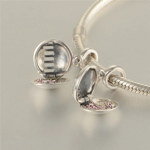 Detail of opening 925 silver globe charm with pink stones on a silver snake chain