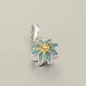 Macro shot of S925 silver flower pendant with blue enamel, gold accents and zircon stone