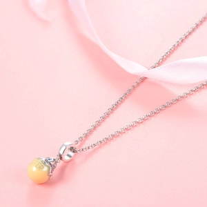 S925 sterling silver chain necklace with yellow sister pendant and pink ribbon background