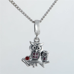 Close-up of owl pendant with purple and red zircons on sterling silver chain