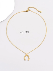 Detail shot of golden U-shaped pendant with crystal inlay on 40+5CM stainless steel chain