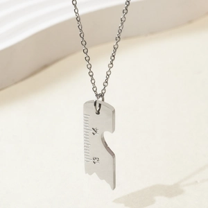 Detailed view of stainless steel broken ruler necklace with numbers 13 and 14 engraving