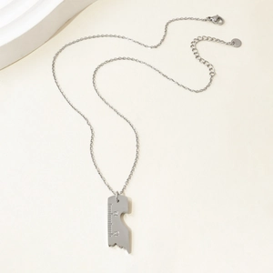 Macro shot of industrial ruler pendant showing precise scale marks and 1314 engravings