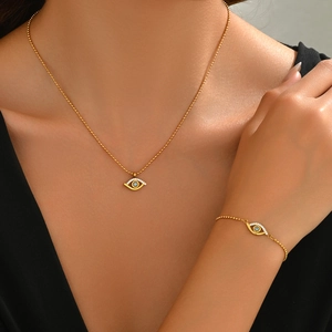 Detailed view of evil eye bracelet and necklace set in gold finish with blue stones