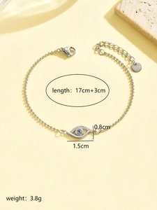 Detailed view of evil eye bracelet pendant with blue stones and S.Steel logo tag