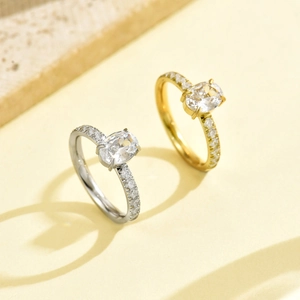 Elegant stainless steel ring with large oval-cut gemstone and pave diamond accents