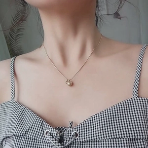 Elegant gold titanium steel necklace featuring frosted round bead pendants on a thin chain