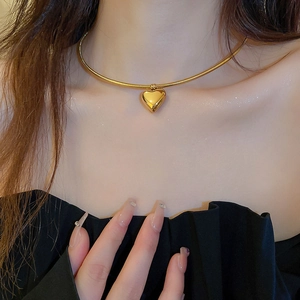 Elegant gold heart pendant necklace for women with a sleek snake bone chain accessory
