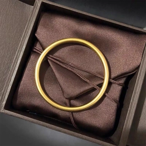 Matte gold titanium steel bangle presented in a premium wooden jewelry gift box