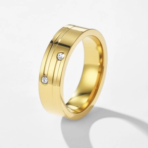 Close-up of golden stainless steel ring with dual grooves and two round diamonds