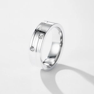 Polished stainless steel ring with parallel lines and two round cut stones