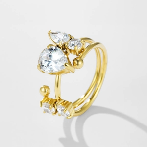Detailed macro view of a gold-tone open ring with pear-cut and round cubic zirconia stones