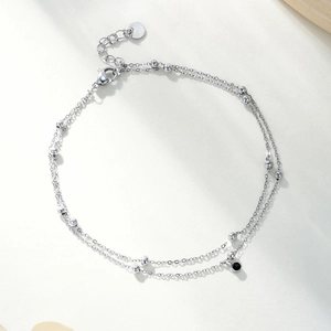 Detail of silver double-layered bead chain with a small black round pendant and lobster clasp