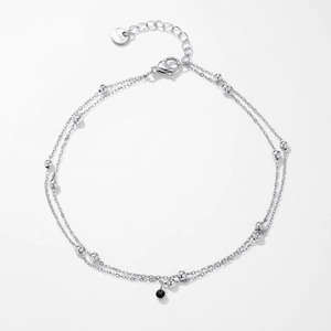 Detailed close-up of double-layer stainless steel anklet with beads and black zircon stone
