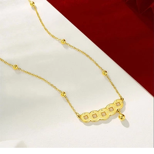Detail van de 24K vergulde ketting met Chinese munten hanger en kwastje kraal