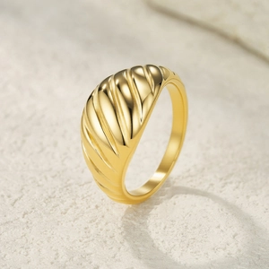 Minimalist gold croissant ring with textured geometric lines on polished stainless steel