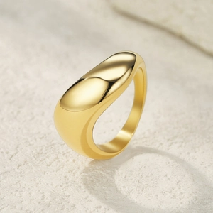Detailed view of a golden minimalist ring with organic curved lines and polished finish