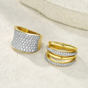 Detailed macro view of gold plated multi-layer rings with shimmering pave zircon stones