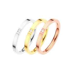 Minimalist titanium steel ring set in gold silver and rose gold with a single diamond