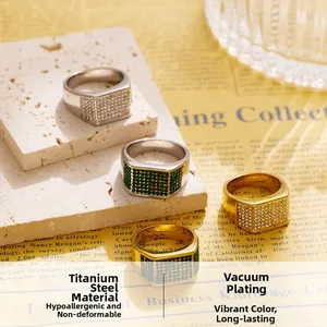 Macro view of four titanium steel hip-hop rings with pavé cubic zirconia on stone background