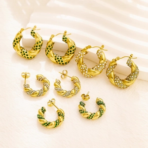 Golden twisted hoop earrings set with sparkling green and white zircon stones