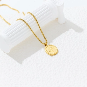 Macro shot of 18k gold plated oval sunflower pendant on a rope chain with retro design