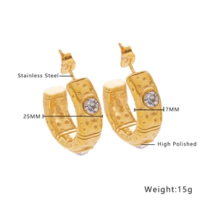 Gros plan de boucles d'oreilles C dorées de 25 mm en acier inoxydable avec zircons